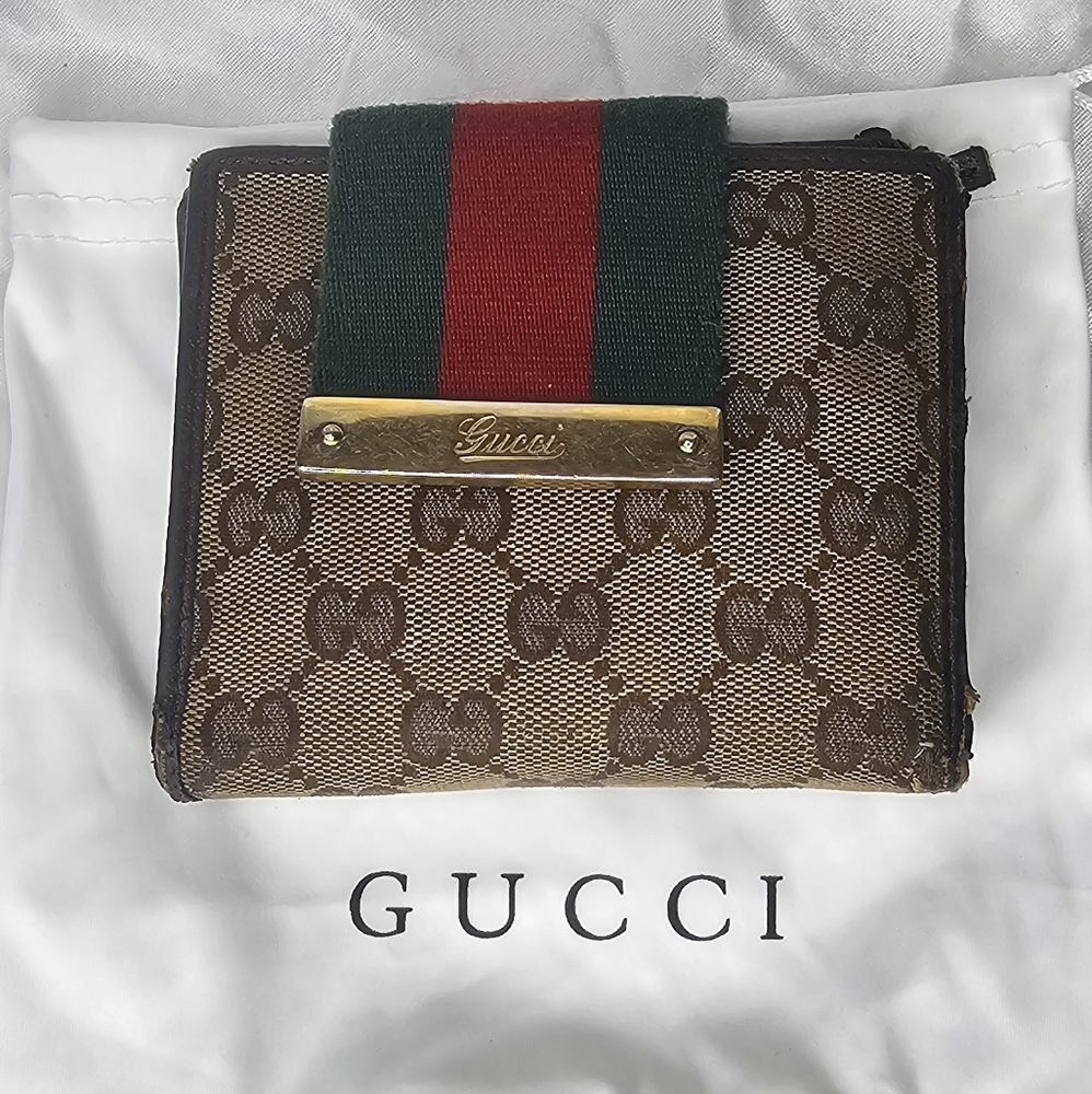 Gucci Wallet Canvas GG print with brown leather and red and green strap.